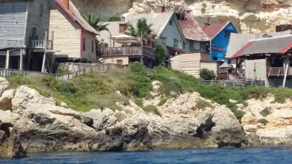 Panoramic view of Anchor Bay and Popeye Village on Malta’s north-west coast.  The attraction occupies a steep waterfront site near Mellieħa.