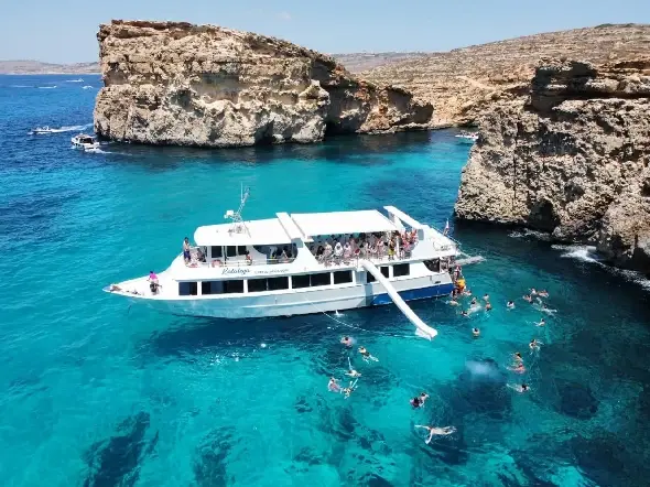 From Sliema: Crystal Lagoon & Blue Lagoon Cruise From the boat into the water via the slide and easily back on board via the steps. From Sliema: Crystal Lagoon & Blue Lagoon Cruise