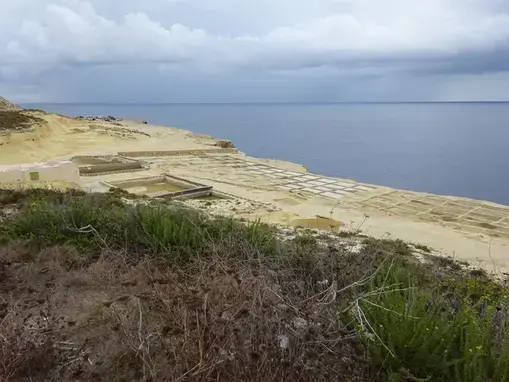 The working salt-pan landscape stretches along the limestone coast between Xwejni and Reqqa Point.